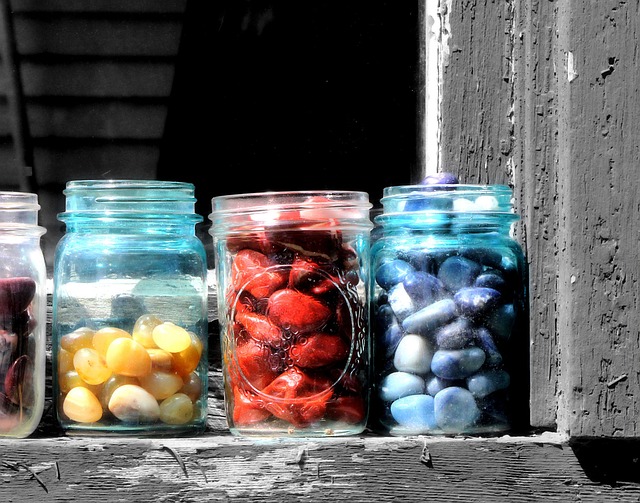 jars of grapes, strawberries and blueberries on a windowsill